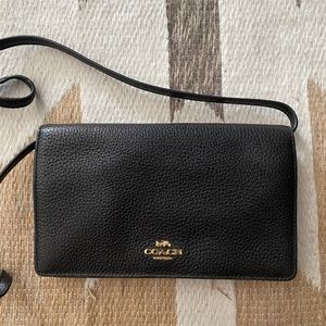 black leather Coach wallet with strap